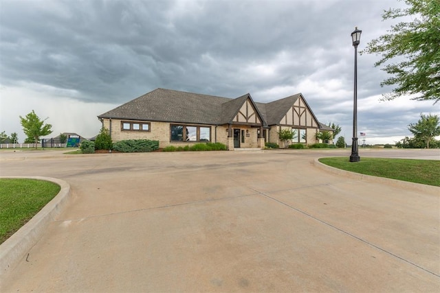 8040 Sweetgum St, Edmond, OK 73034 - tudor-style house featuring curved driveway