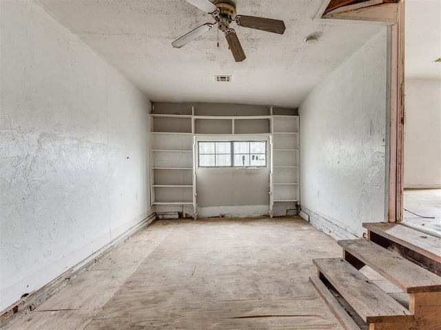 816 NE 31st St, Oklahoma City, OK 73105 - unfurnished room featuring a ceiling fan, a textured wall, and vaulted ceiling