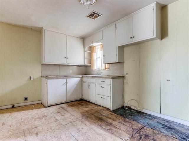 816 NE 31st St, Oklahoma City, OK 73105 - kitchen with open shelves, white cabinetry, and light countertops