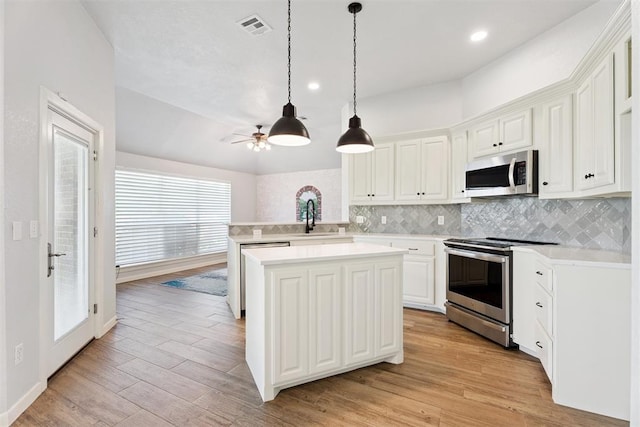 3343 Teton Cir, Norman, OK 73072 - kitchen with stainless steel appliances, light countertops, backsplash, ceiling fan, and light wood-style floors