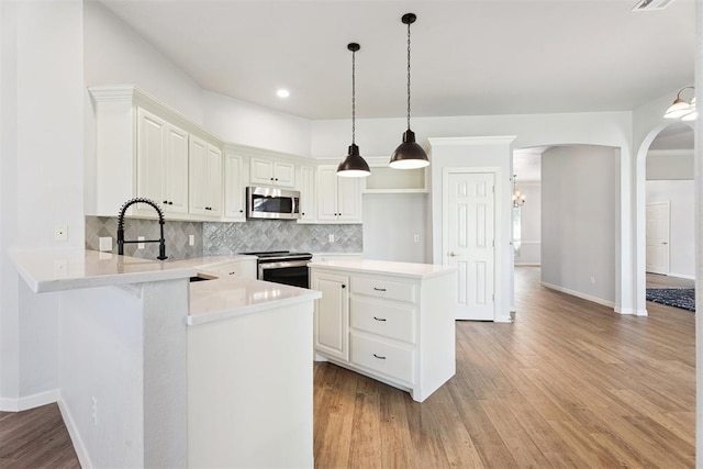 3343 Teton Cir, Norman, OK 73072 - kitchen featuring appliances with stainless steel finishes, light wood-type flooring, decorative backsplash, light countertops, and recessed lighting