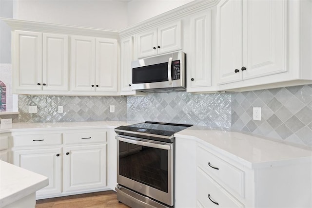 3343 Teton Cir, Norman, OK 73072 - kitchen featuring stainless steel appliances, white cabinets, and decorative backsplash