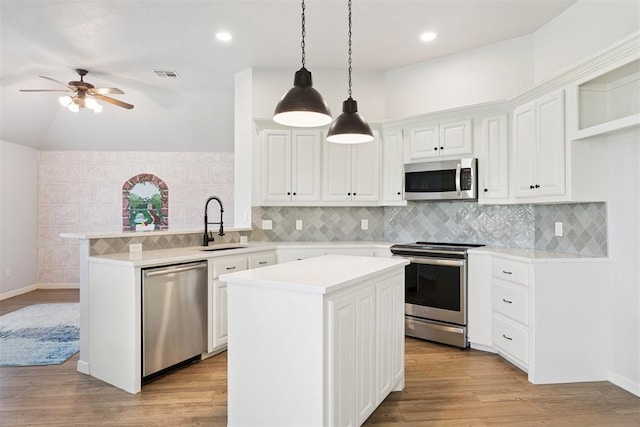 3343 Teton Cir, Norman, OK 73072 - kitchen with stainless steel appliances, a peninsula, ceiling fan, light countertops, and white cabinets