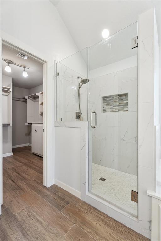 3343 Teton Cir, Norman, OK 73072 - bathroom with a marble finish shower, wood finished floors, and a spacious closet