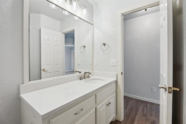 3343 Teton Cir, Norman, OK 73072 - bathroom featuring wood finished floors, vanity, and a textured wall