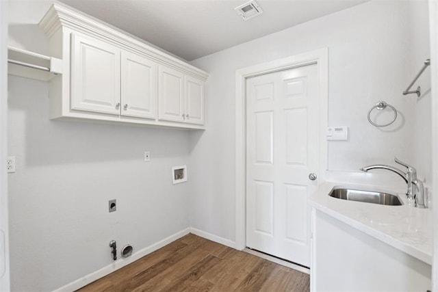 3343 Teton Cir, Norman, OK 73072 - laundry area featuring cabinet space, dark wood finished floors, gas dryer hookup, hookup for a washing machine, and electric dryer hookup