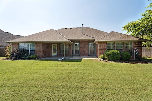 3343 Teton Cir, Norman, OK 73072 - view of front of house with a patio area, brick siding, and a shingled roof