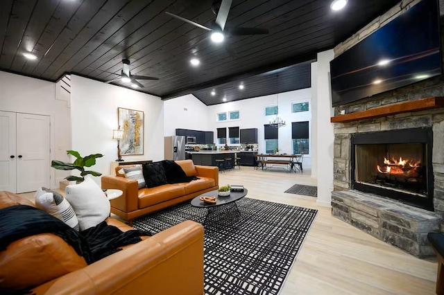 156 Butternut Trl, Broken Bow, OK 74728 - living room with ceiling fan, light wood-style floors, a stone fireplace, and wooden ceiling