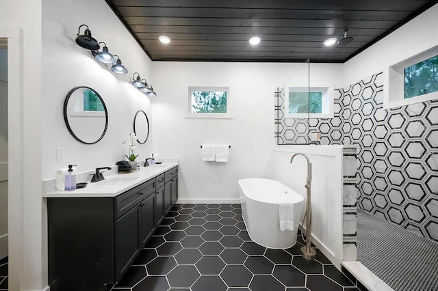 156 Butternut Trl, Broken Bow, OK 74728 - bathroom featuring double vanity, a walk in shower, a soaking tub, tile patterned floors, and recessed lighting