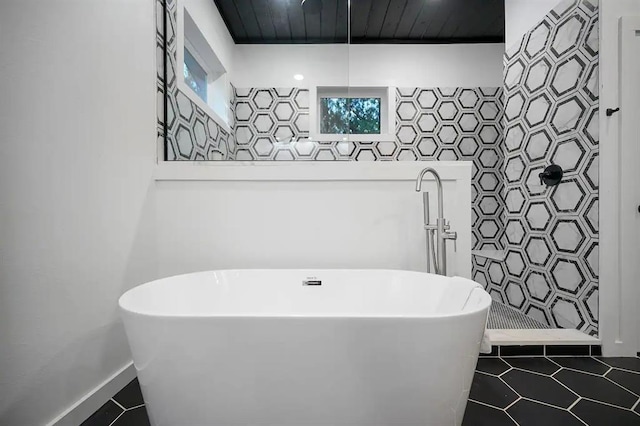 156 Butternut Trl, Broken Bow, OK 74728 - bathroom featuring a soaking tub, tile patterned flooring, and wood ceiling