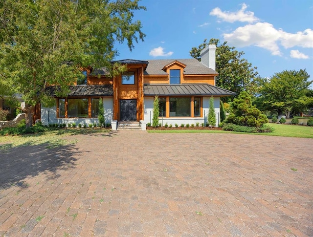 1725 Huntington Ave, Nichols Hills, OK 73116 - view of front of property featuring a standing seam roof, a chimney, and a metal roof