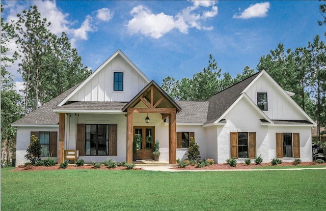 7231 Vista Springs Dr, Norman, OK 73026 - modern inspired farmhouse with board and batten siding, french doors, roof with shingles, and a front yard