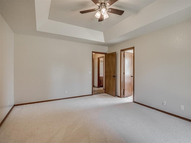 400 Ryan Way, Edmond, OK 73003 - spare room with light carpet, a ceiling fan, and a raised ceiling