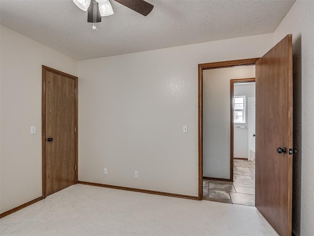400 Ryan Way, Edmond, OK 73003 - empty room featuring ceiling fan, a textured ceiling, and light carpet