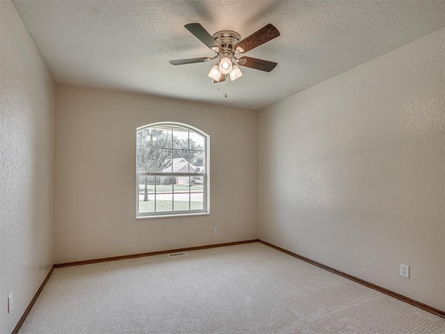 400 Ryan Way, Edmond, OK 73003 - carpeted spare room featuring ceiling fan, a textured ceiling, and a textured wall