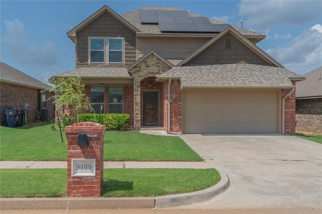 9409 NW 91st St, Yukon, OK 73099 - view of front of property featuring driveway, roof mounted solar panels, an attached garage, and a front yard