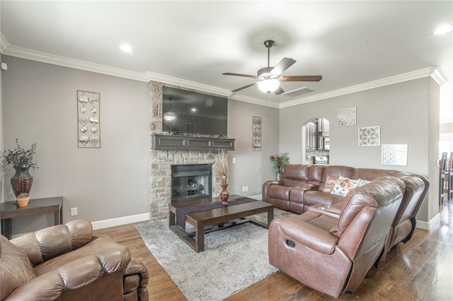 9409 NW 91st St, Yukon, OK 73099 - living area with arched walkways, a ceiling fan, ornamental molding, wood finished floors, and a fireplace