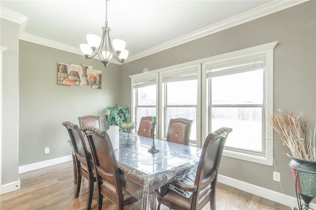9409 NW 91st St, Yukon, OK 73099 - dining space with a chandelier, crown molding, and light wood-style flooring