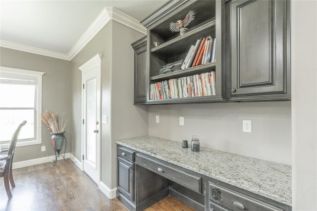 9409 NW 91st St, Yukon, OK 73099 - kitchen with ornamental molding, light wood finished floors, light stone counters, built in desk, and open shelves