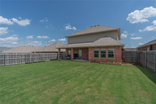 9409 NW 91st St, Yukon, OK 73099 - rear view of property with brick siding, a fenced backyard, and a patio area