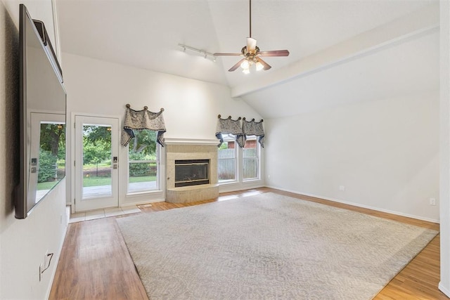 812 Old Bugle Rd, Edmond, OK 73003 - unfurnished living room with ceiling fan, light wood-type flooring, and a tiled fireplace
