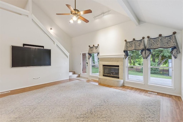 812 Old Bugle Rd, Edmond, OK 73003 - unfurnished living room with wood finished floors, healthy amount of natural light, ceiling fan, and a glass covered fireplace
