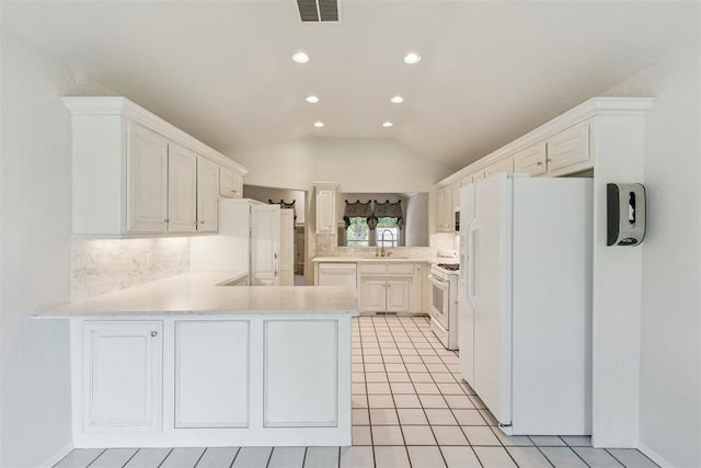 812 Old Bugle Rd, Edmond, OK 73003 - kitchen with white appliances, a peninsula, backsplash, light countertops, and recessed lighting