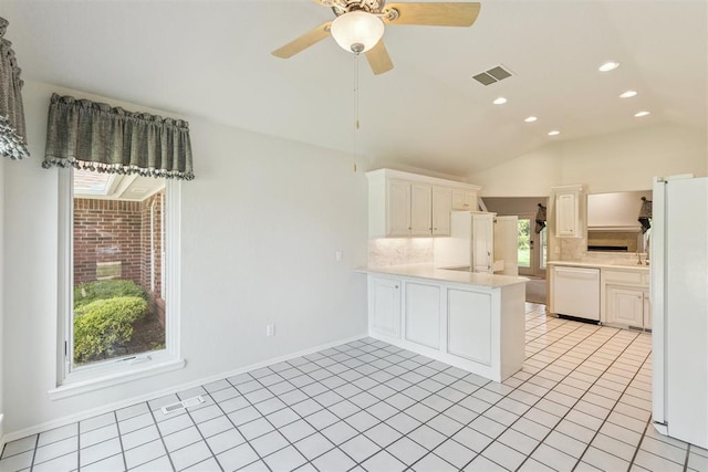 812 Old Bugle Rd, Edmond, OK 73003 - kitchen featuring white appliances, a peninsula, vaulted ceiling, backsplash, and light countertops