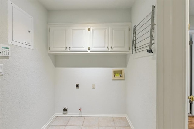 812 Old Bugle Rd, Edmond, OK 73003 - laundry area with hookup for a gas dryer, washer hookup, electric dryer hookup, cabinet space, and light tile patterned floors