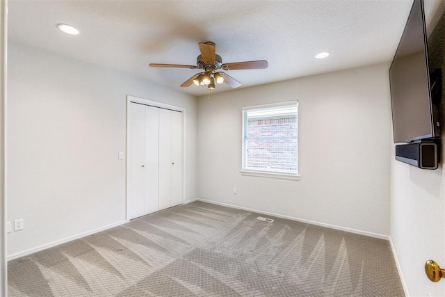 812 Old Bugle Rd, Edmond, OK 73003 - unfurnished bedroom with carpet flooring, a closet, ceiling fan, and recessed lighting