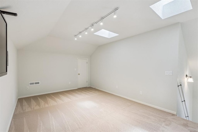 812 Old Bugle Rd, Edmond, OK 73003 - bonus room featuring a skylight, light colored carpet, and lofted ceiling