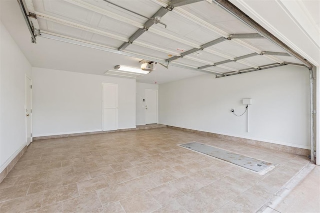 812 Old Bugle Rd, Edmond, OK 73003 - garage with a garage door opener and baseboards