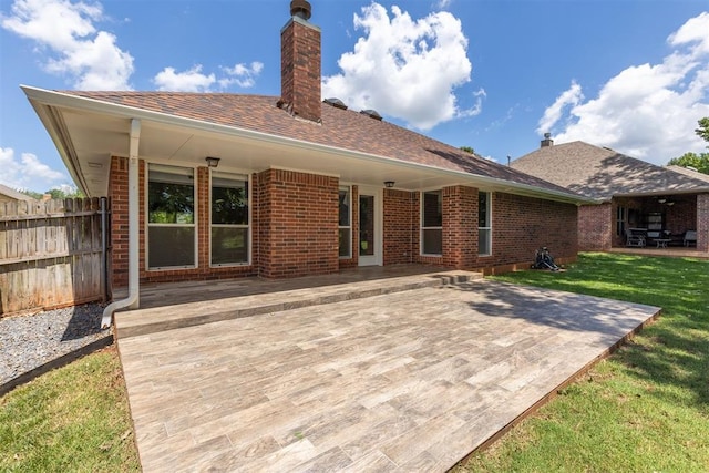 812 Old Bugle Rd, Edmond, OK 73003 - back of property with brick siding, a patio area, a chimney, and roof with shingles