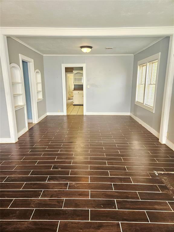 934 E Elm St, Altus, OK 73521 - unfurnished room with ornamental molding and built in features