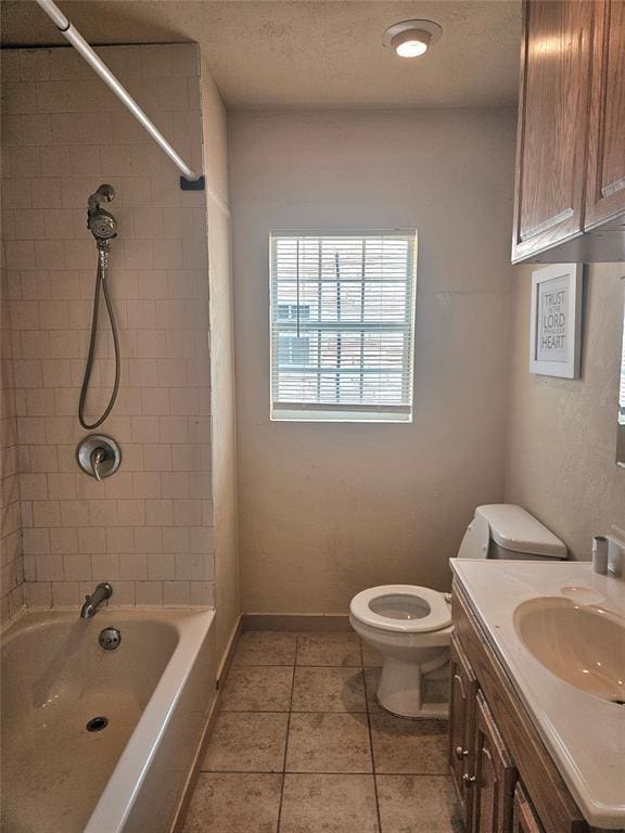 934 E Elm St, Altus, OK 73521 - bathroom featuring vanity, washtub / shower combination, tile patterned flooring, and a textured ceiling