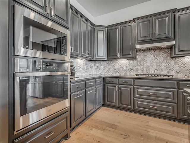 3760 Black Mesa Rd, Norman, OK 73071 - kitchen featuring appliances with stainless steel finishes, light wood-style flooring, and backsplash