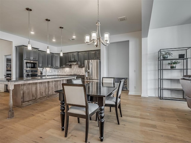 3760 Black Mesa Rd, Norman, OK 73071 - dining space with a chandelier, light wood-type flooring, and recessed lighting
