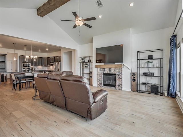 3760 Black Mesa Rd, Norman, OK 73071 - living area featuring light wood-style floors, ceiling fan, beam ceiling, a chandelier, and a brick fireplace