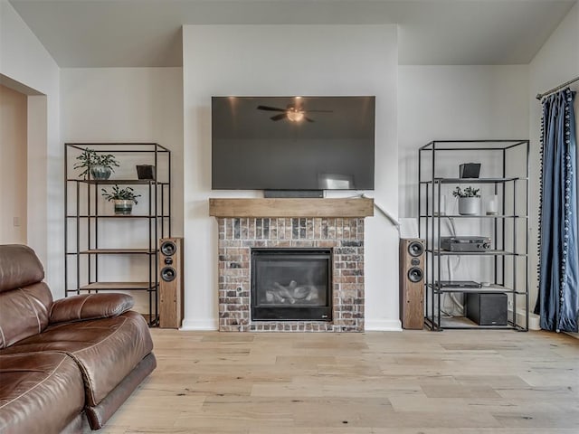 3760 Black Mesa Rd, Norman, OK 73071 - living area featuring wood finished floors, a brick fireplace, and a ceiling fan