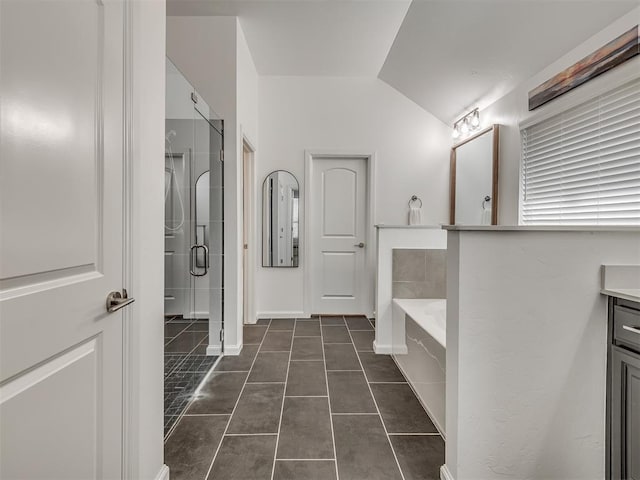 3760 Black Mesa Rd, Norman, OK 73071 - full bath featuring vanity, a bath, tile patterned flooring, a stall shower, and vaulted ceiling