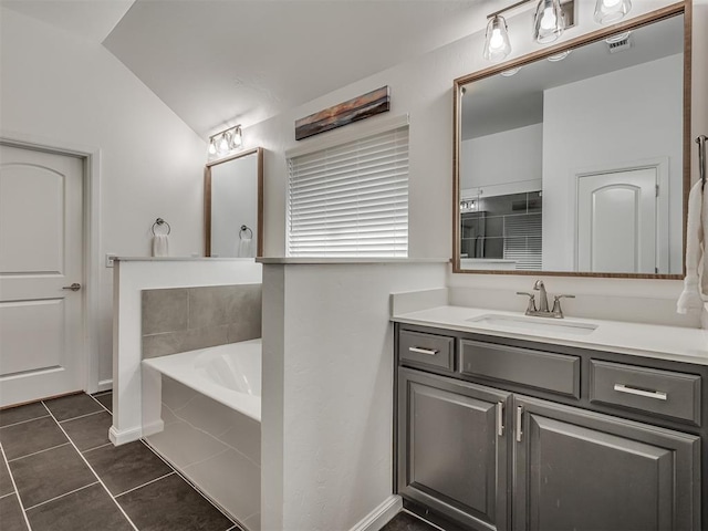 3760 Black Mesa Rd, Norman, OK 73071 - bathroom featuring vaulted ceiling, tile patterned flooring, a garden tub, and vanity