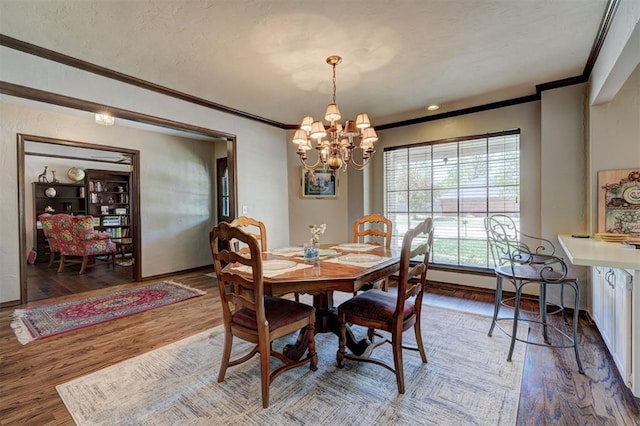 12108 Blue Sage Rd, Oklahoma City, OK 73120 - dining room featuring ornamental molding, a chandelier, and wood finished floors