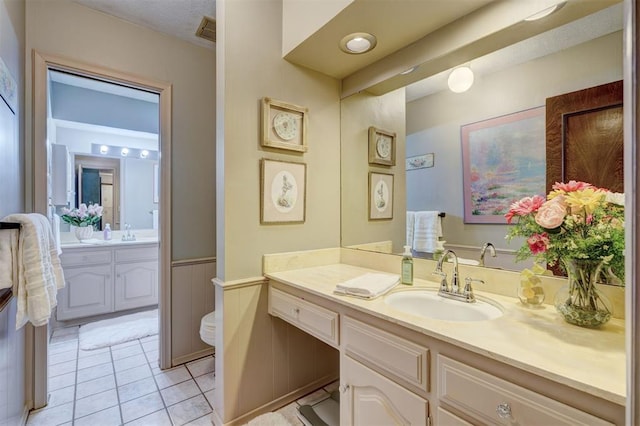 12108 Blue Sage Rd, Oklahoma City, OK 73120 - bathroom featuring vanity, wainscoting, and tile patterned floors