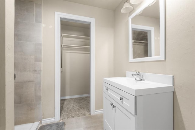 1361 Chestnut Dr, Oklahoma City, OK 73119 - bathroom with vanity, tiled shower, and a walk in closet
