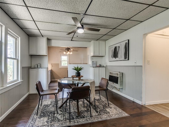 610 N Choctaw Ave, El Reno, OK 73036 - dining area featuring a ceiling fan, dark wood-style flooring, heating unit, wood walls, and a wainscoted wall