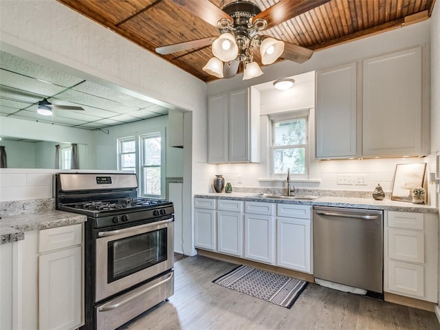 610 N Choctaw Ave, El Reno, OK 73036 - kitchen with ceiling fan, stainless steel appliances, plenty of natural light, light wood-style floors, and wooden ceiling