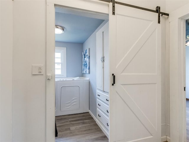 610 N Choctaw Ave, El Reno, OK 73036 - laundry area featuring wood finished floors, separate washer and dryer, and a barn door