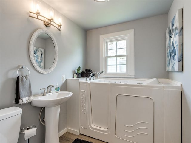 610 N Choctaw Ave, El Reno, OK 73036 - bathroom with a garden tub and wood finished floors
