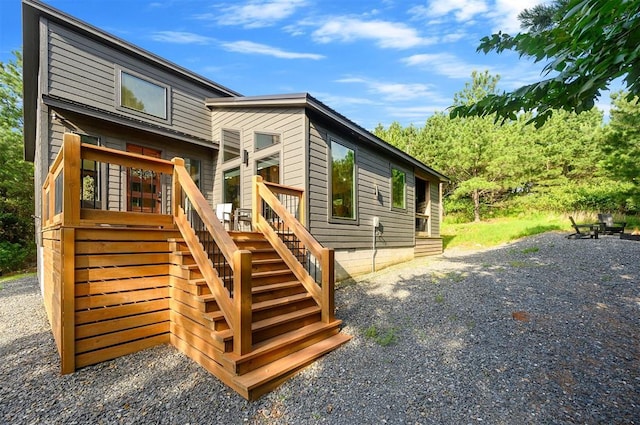 105 S Spruce Trl, Broken Bow, OK 74728 - back of property with stairway and a deck