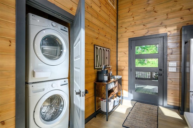 105 S Spruce Trl, Broken Bow, OK 74728 - washroom with estacked washer and dryer, wood walls, and wood finished floors